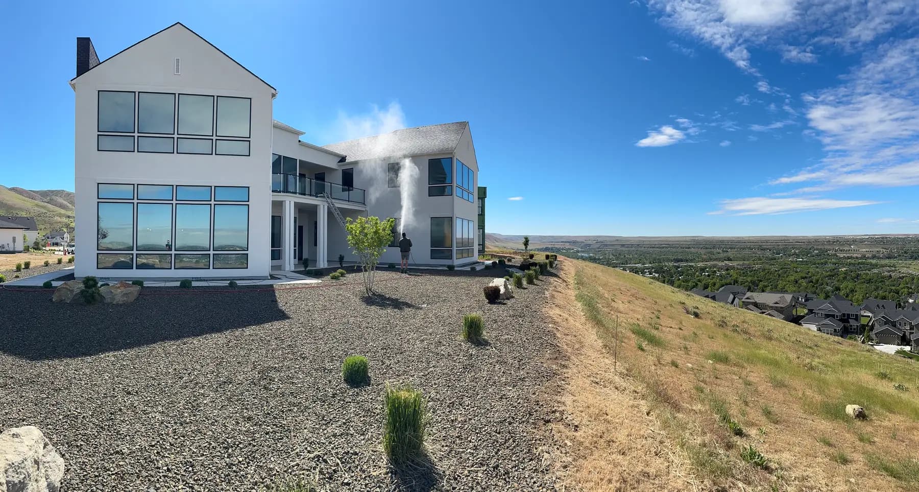 Soft washing on a hillside home exterior near Eagle, Idaho — Sol Pressure Washing