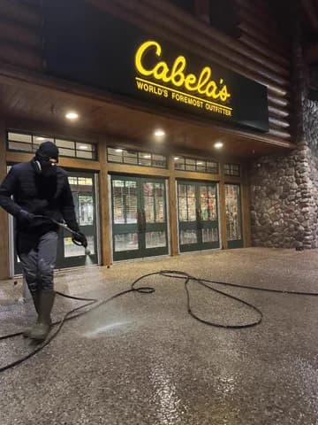 Night pressure washing at Cabela's storefront entrance