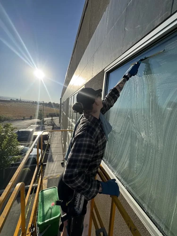 Commercial window cleaning from a lift with a squeegee in Boise
