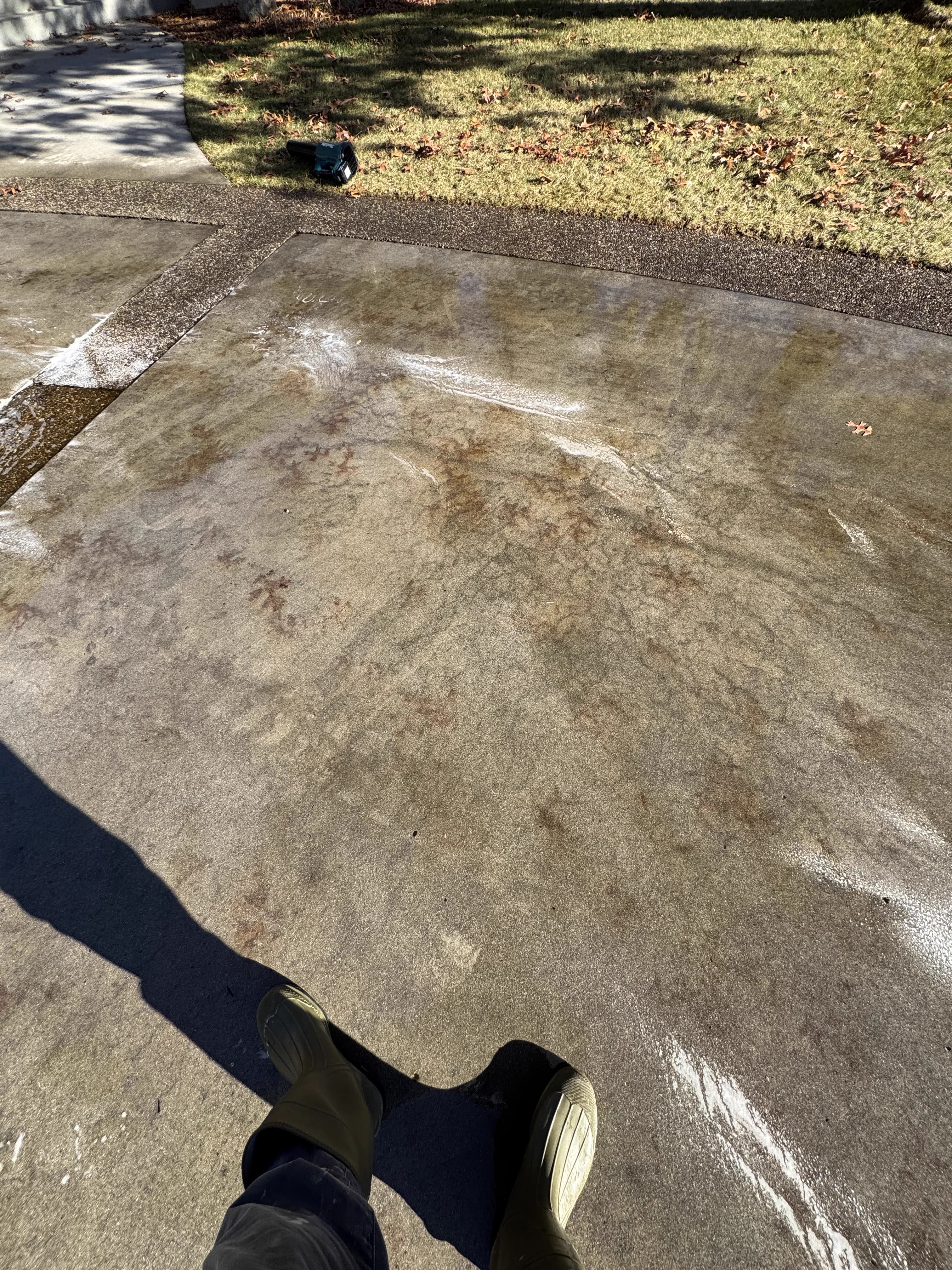 Residential driveway pressure washing in progress